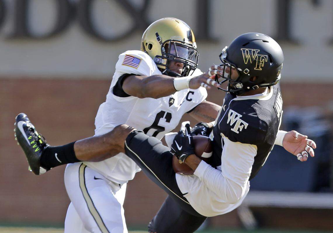 In this 2014 file photo, Wake Forest wide receiver Matt James, right, catches a pass as Army defensive back Geoffery Bacon, left, defends during a game in Winston-Salem, N.C., Sept. 20, 2014.