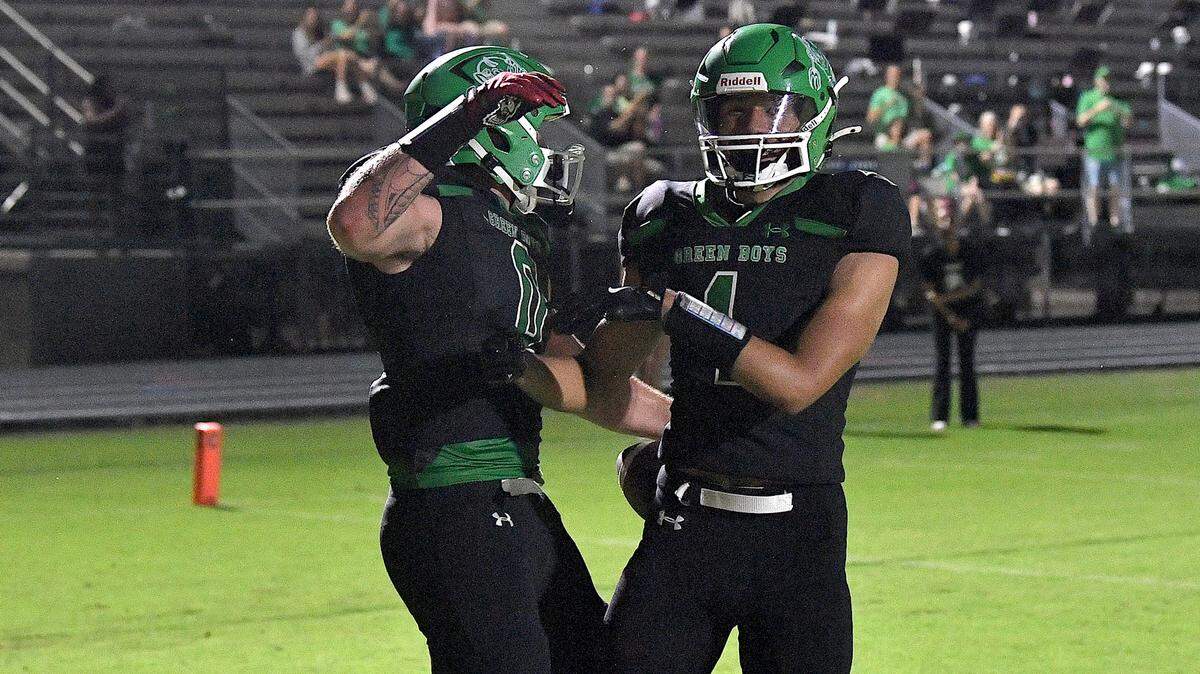 Cary’s Gus Ritchey (0) celebrates his touchdown run against Athens Drive late in the first half with Adan Knight (1). The Cary Imps and the Athens Drive Jaguars met in a football game in Cary, N.C. on September 6, 2024. Athens Drive wins 28-13.