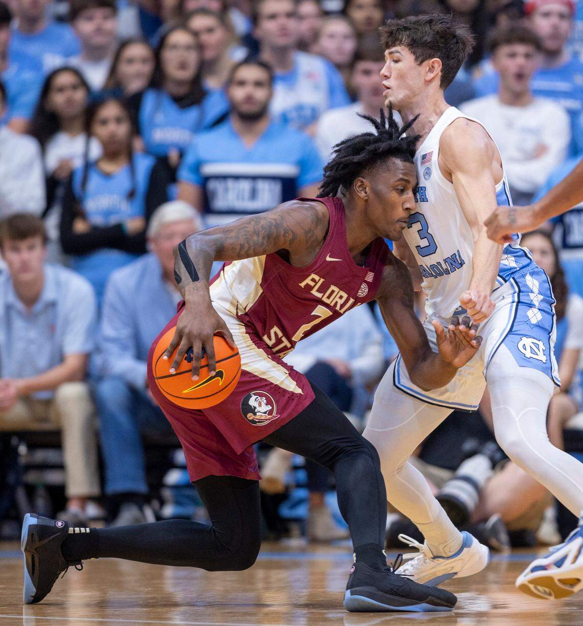 North Carolina’s Cormac Ryan (3) stops Florida State’s Jamir Watkins (2) as he drives to the basket in the first half on Saturday, December 2, 2023 at the Smith Center in Chapel Hill, N.C.