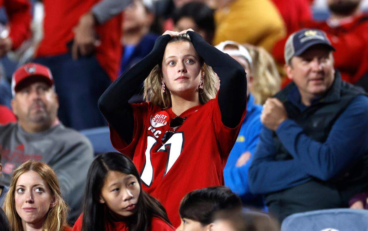 Wolfpack fans react after Kansas State scored in the fourth quarter of Kansas State’s 28-19 victory over N.C. State in the Pop-Tarts Bowl at Camping World Stadium in Orlando, Fla., Thursday, Dec. 28, 2023.