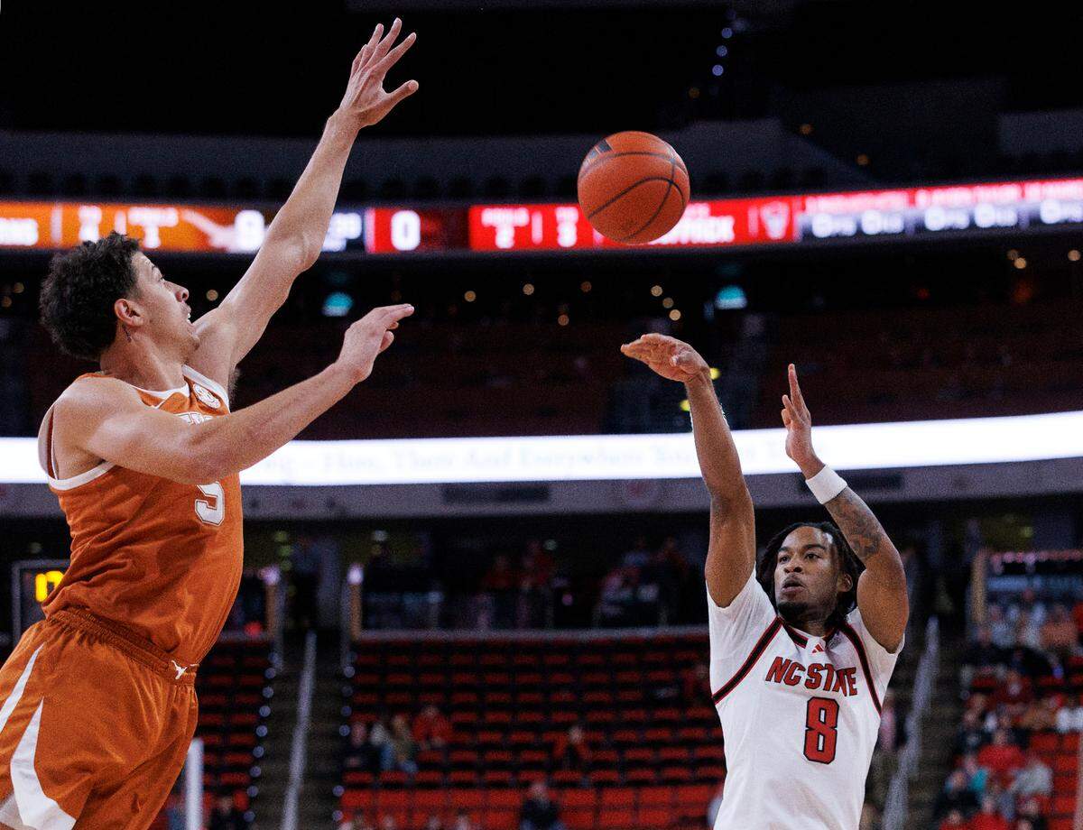 N.C. State’s Jayden Taylor shoots over Texas’ Kadin Shedrick during the first half of the Wolfpack’s game on Wednesday, Dec. 4, 2024, at Lenovo Center in Raleigh, N.C.