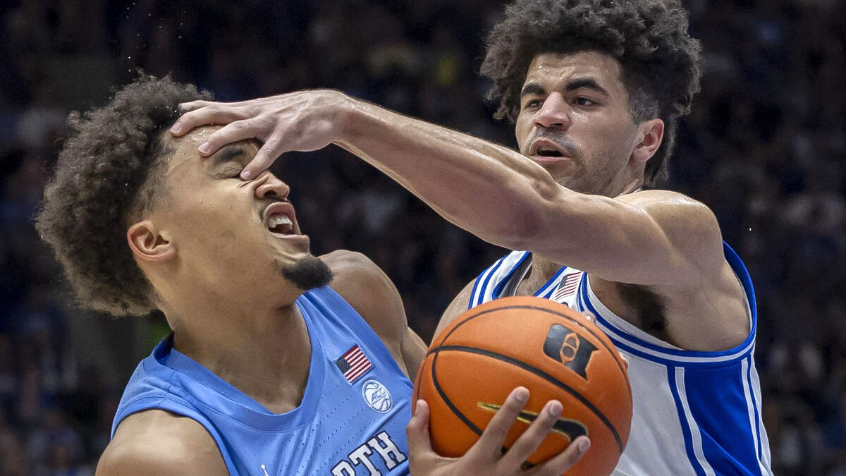 Duke guard Cayden Boozer (2) pokes North Carolina guard Seth Trimble (7) in the eye during the second half on Saturday, March 7, 2026 at Cameron Indoor Stadium in Durham, N.C.