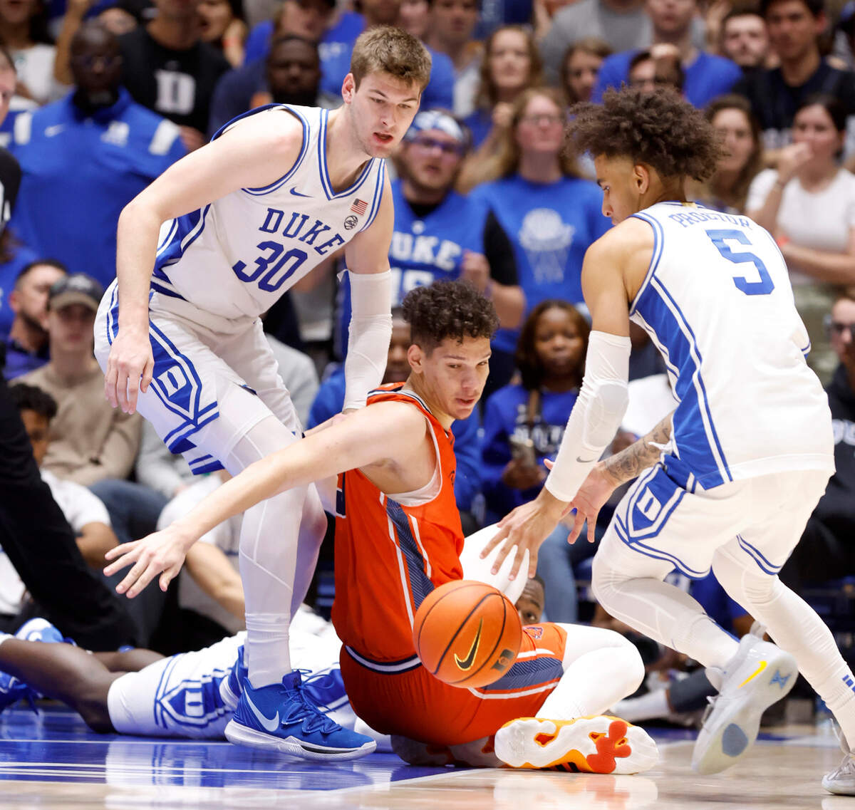 Duke’s Kyle Filipowski (30), Tyrese Proctor (5) and Bucknell’s Noah Williamson (3) go after the loose ball during the second half of Duke’s 90-60 victory over Bucknell at Cameron Indoor Stadium in Durham, N.C., Friday, Nov. 17, 2023.