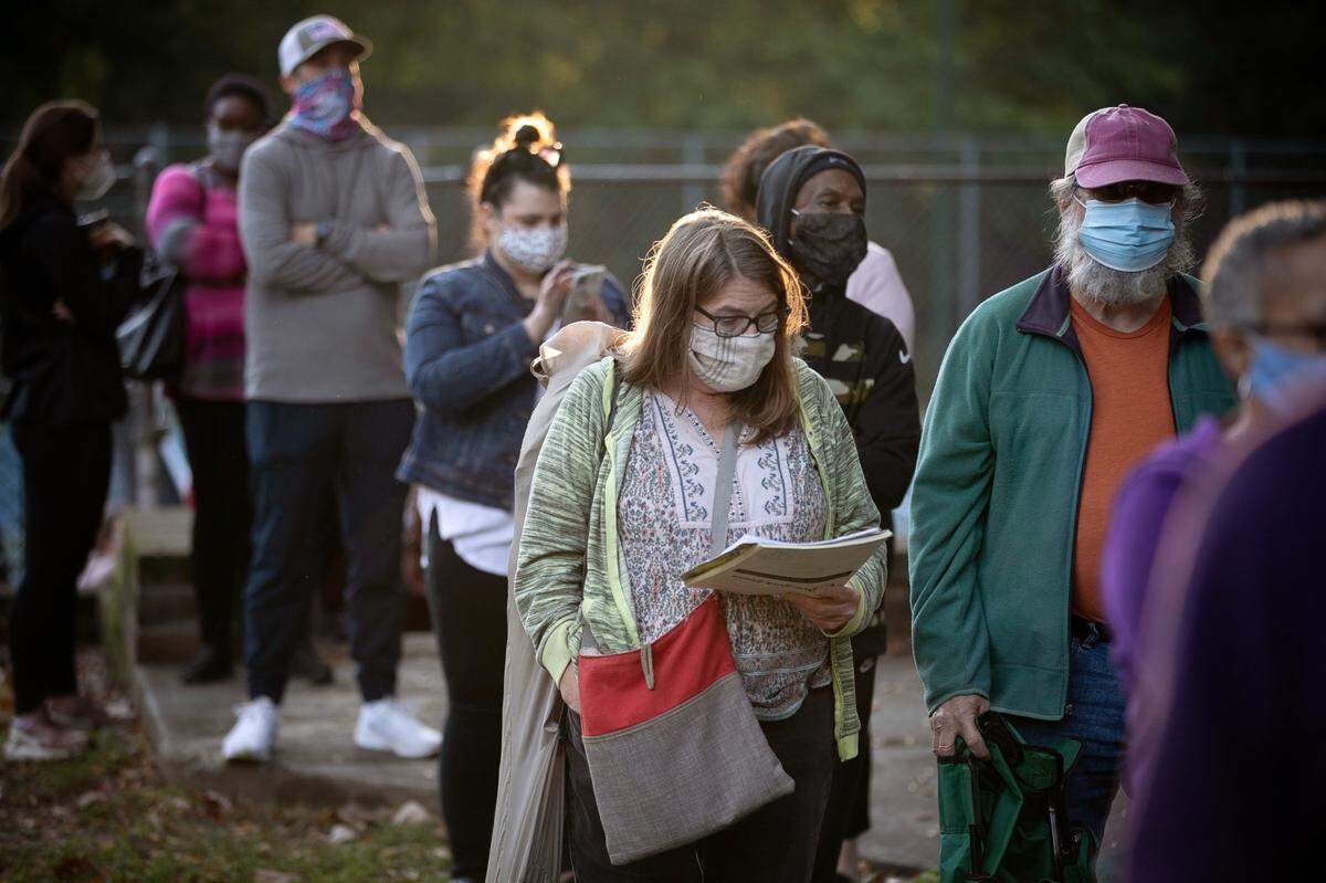 People wait in line to vote on Thursday morning, October 15, 2020 at Roberts Park in Raleigh, N.C. More than 300 people who were in line when the poll opened at 8 a.m..