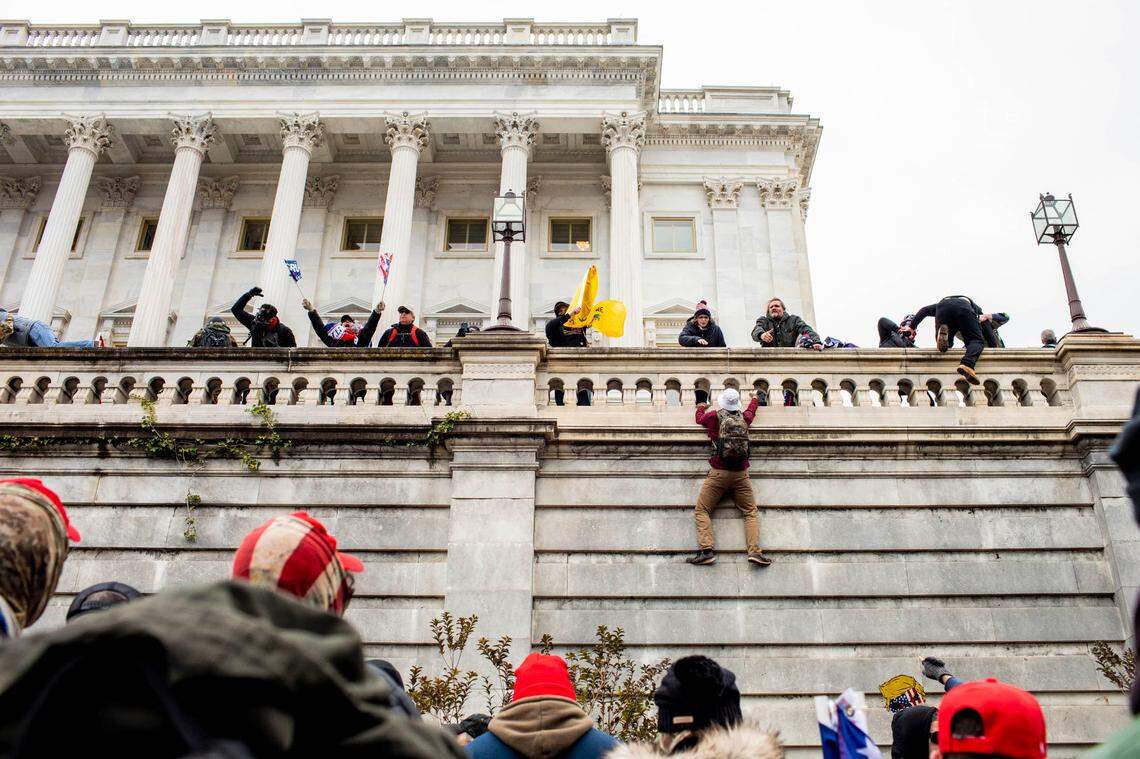 Protestors climb the Capitol in Washington on Wednesday, Jan. 6, 2021. The Capitol building was placed on lockdown, with senators and members of the House locked inside their chambers, as Congress began debating President-elect Joe Biden’s victory. President Trump addressed supporters near the White House before protesters marched to Capitol Hill. (Jason Andrew/The New York Times)