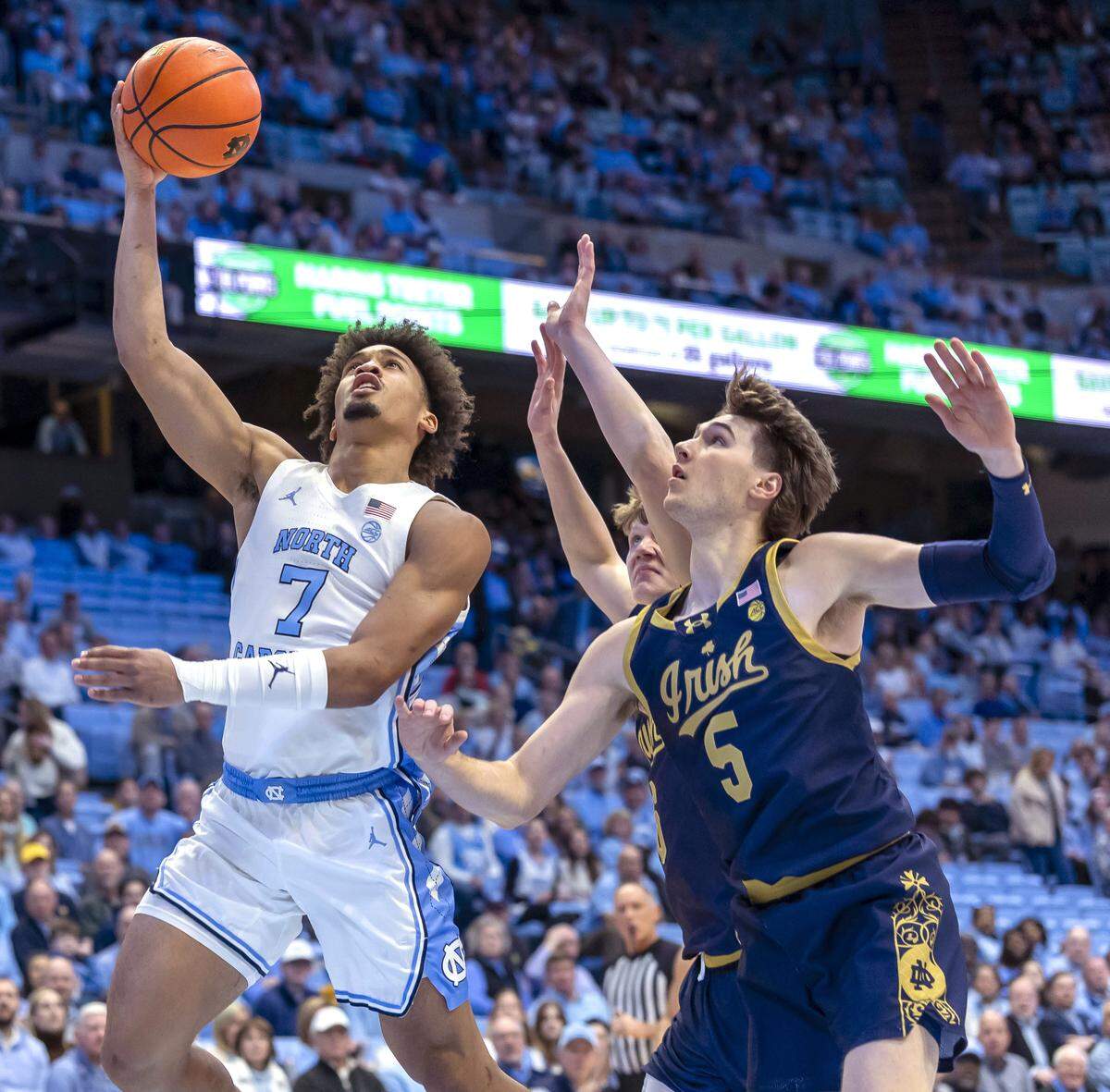 North Carolina guard Seth Trimble (7) breaks to the basket against Notre Dame guard Cole Certa (5) in the first half  on Wednesday, January 21, 2026 at the Smith Center in Chapel Hill, N.C. 