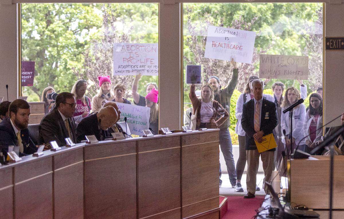 Demonstrators hold signs outside the legislature auditorium where a House Rules meeting&nbsp;was underway, May 3, 2023 at the Legislative Building. Republican state lawmakers announced their plan to limit abortion rights across the state.