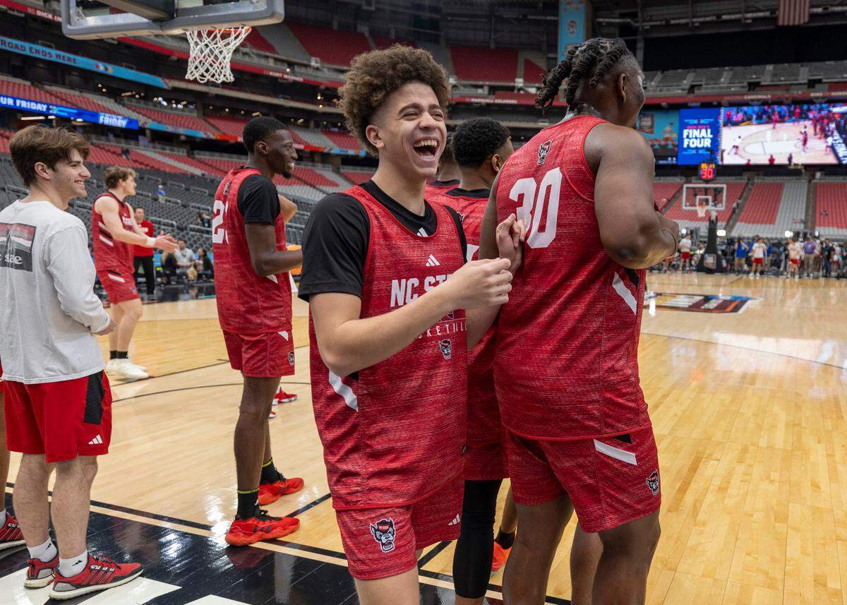 N.C. State’s Jordan Snell (22) laughs with D.J. Burns Jr. (30) during the Wolfpack’s practice on Friday, April 5, 2024, as they prepare for their NCAA National Semi-Final game against Purdue at State Farm Stadium in Glendale, AZ.