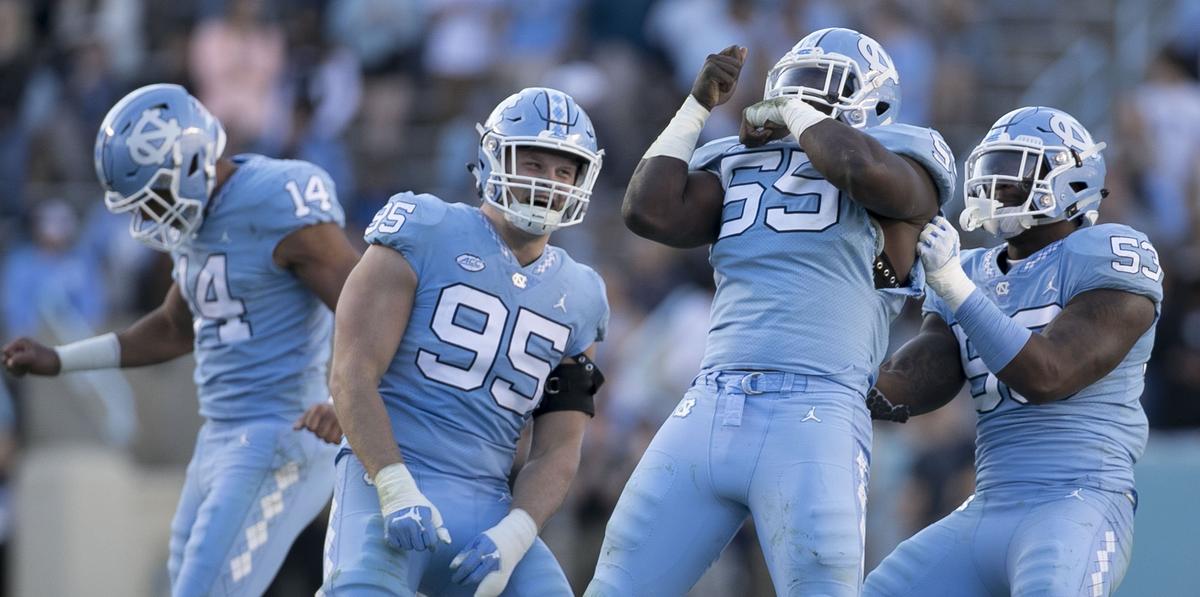 North Carolina’s Jake Lawler (14), Tyler Powell (95), Jason Strowbridge (55), and Malik Carney (53) celebrate after a sack of Western Carolina quarterback Tyrie Adams (12) on Saturday, November 17, 2018 at Kenan Stadium in Chapel Hill.
