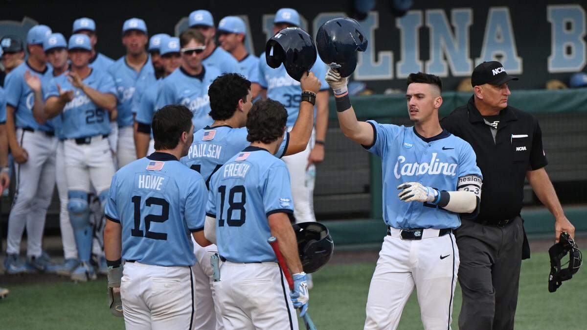 North Carolina Tar Heels catcher Colin Hynek (23) is greeted at the plate after a home run during game 4 of the Chapel Hill Regional at Boshamer Stadium. 