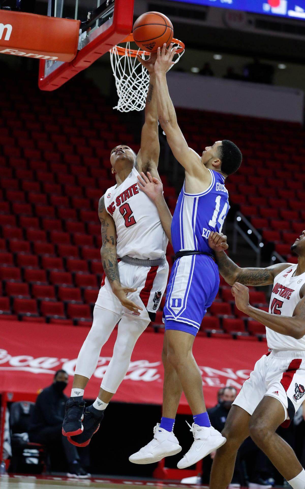 N.C. State’s Shakeel Moore (2) blocks the shot by Duke’s Jordan Goldwire (14) during the second half of Duke’s 69-53 victory over N.C. State at PNC Arena in Raleigh, N.C., Saturday, February 13, 2021.