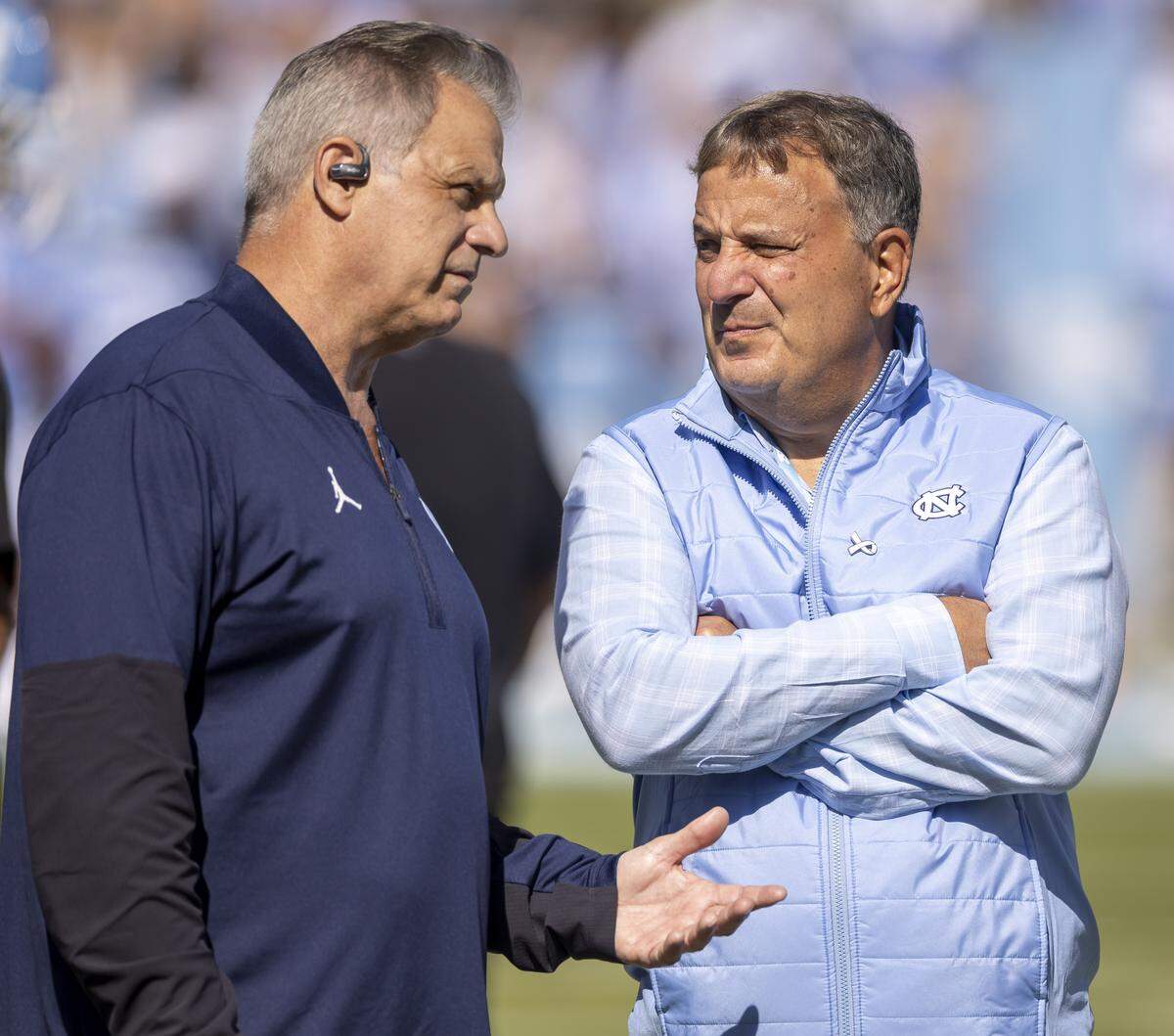 North Carolina football general manager Michael Lombardi, right, walks the sidelines on Saturday, October 4, 2025 at Kenan Stadium in Chapel Hill, N.C.