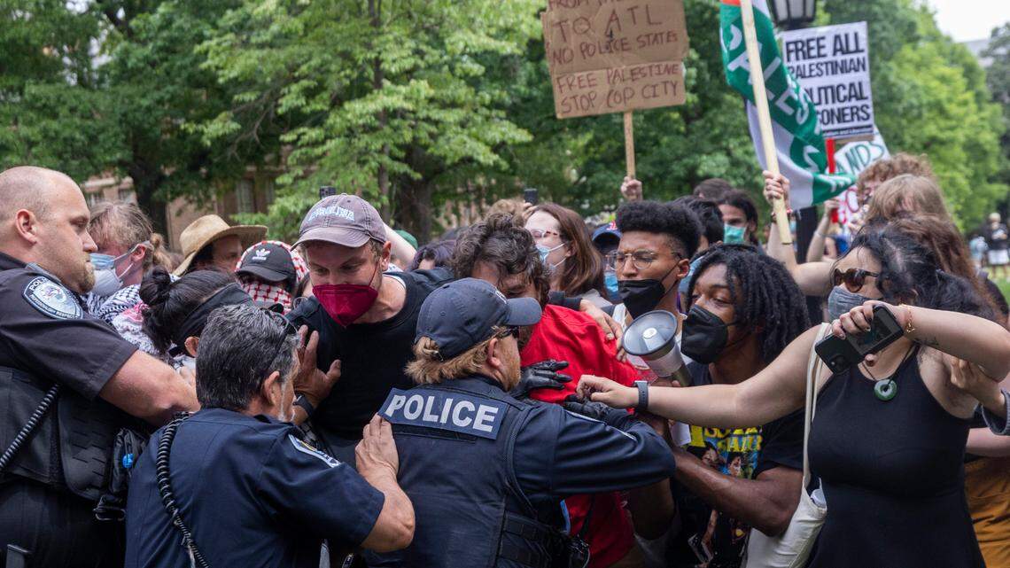 Pro-Palestinian demonstrators clash with police after replacing an American flag with a Palestinian flag Tuesday, April 30, 2024 at UNC-Chapel Hill. Police removed a “Gaza solidarity encampment” earlier Tuesday morning.