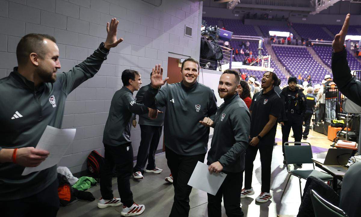 N.C. State head coach Will Wade is congratulated as he comes off the court after N.C. State’s 80-76 overtime victory over Clemson at Littlejohn Coliseum in Clemson, S.C., Tuesday, Jan. 20, 2026.