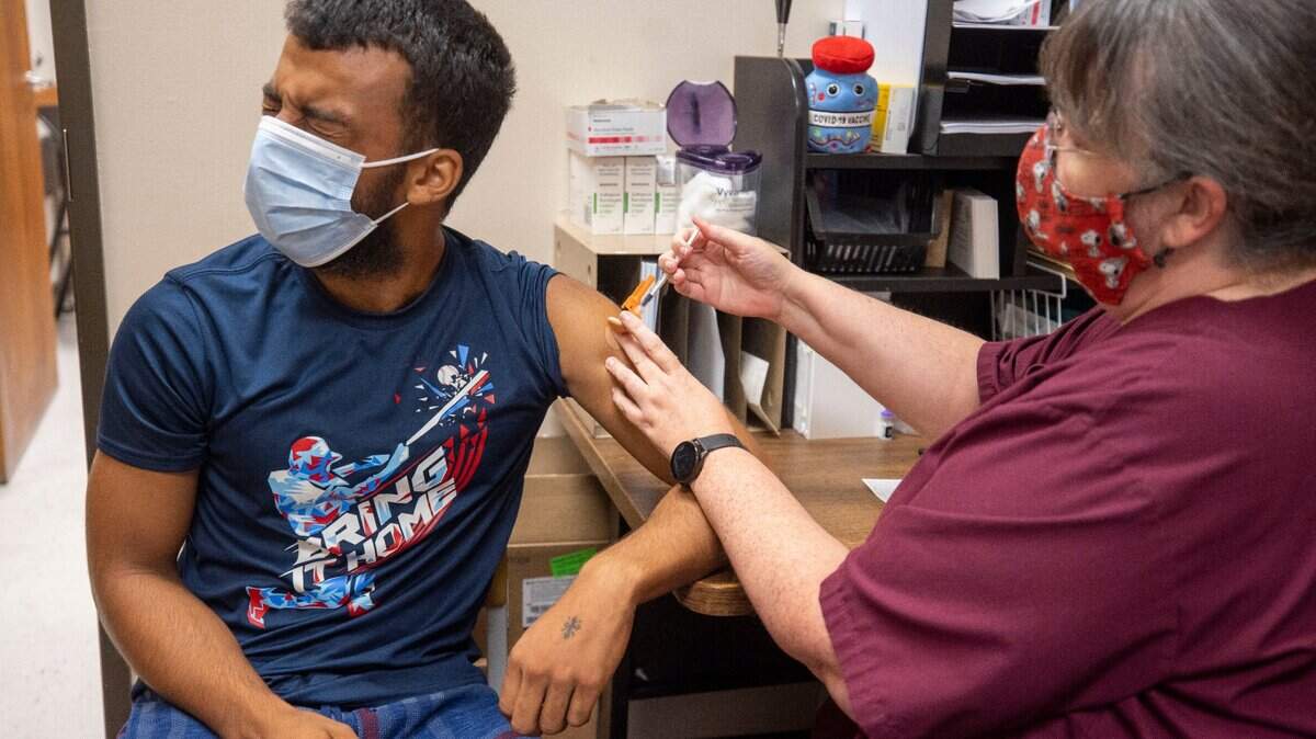 Prather Presley grimaces as he receives his first dose of the Pfizer COVID-19 vaccine at the Robeson County Health Department on Tuesday, August 24, 2021, in Lumberton, N.C. To date only 37% of the Robeson County population has received one dose of the COVID-19 vaccine