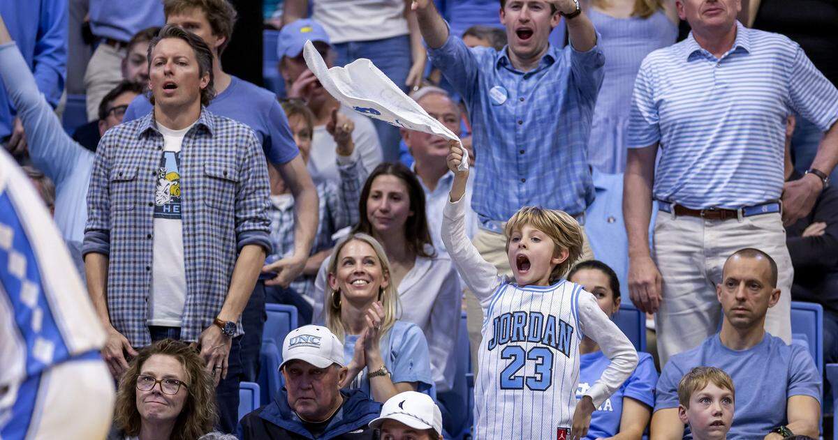 A young enthusiastic North Carolina fan joins others to harass Wade Forest player Nate Calmese at the free-throw line in the second half on Saturday, January 10, 2026 at the Smith Center in Chapel Hill, N.C.
