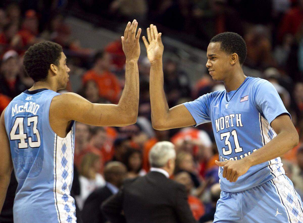 UNC’s John Henson (31) and James Michael McAdoo (43) celebrate the Tar Heels’ 54-51 victory over Virginia on Saturday February 25, 2012 at John Paul Jones Arena in Charlottesville, Virginia.