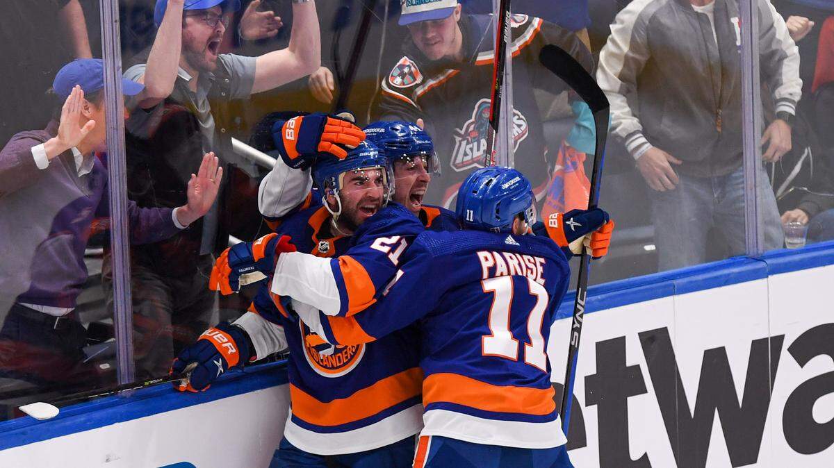 New York Islanders center Kyle Palmieri (21) celebrates his goal against the Carolina Hurricanes with left wing Zach Parise (11) and center Jean-Gabriel Pageau (44) during the third period in game three of the first round of the 2023 Stanley Cup Playoffs at UBS Arena.