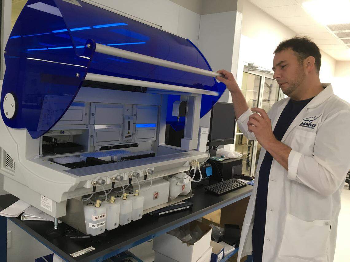 Mako Medical CEO Chad Price with one of the diagnostic machines at the company’s Henderson facility.