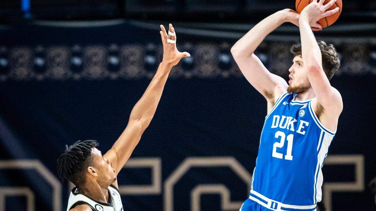 Duke forward Matthew Hurt (21) shoots over defense from Wake Forest forward Ody Oguama (33) on Wednesday, Feb. 17, 2021 in Winston-Salem, N.C.