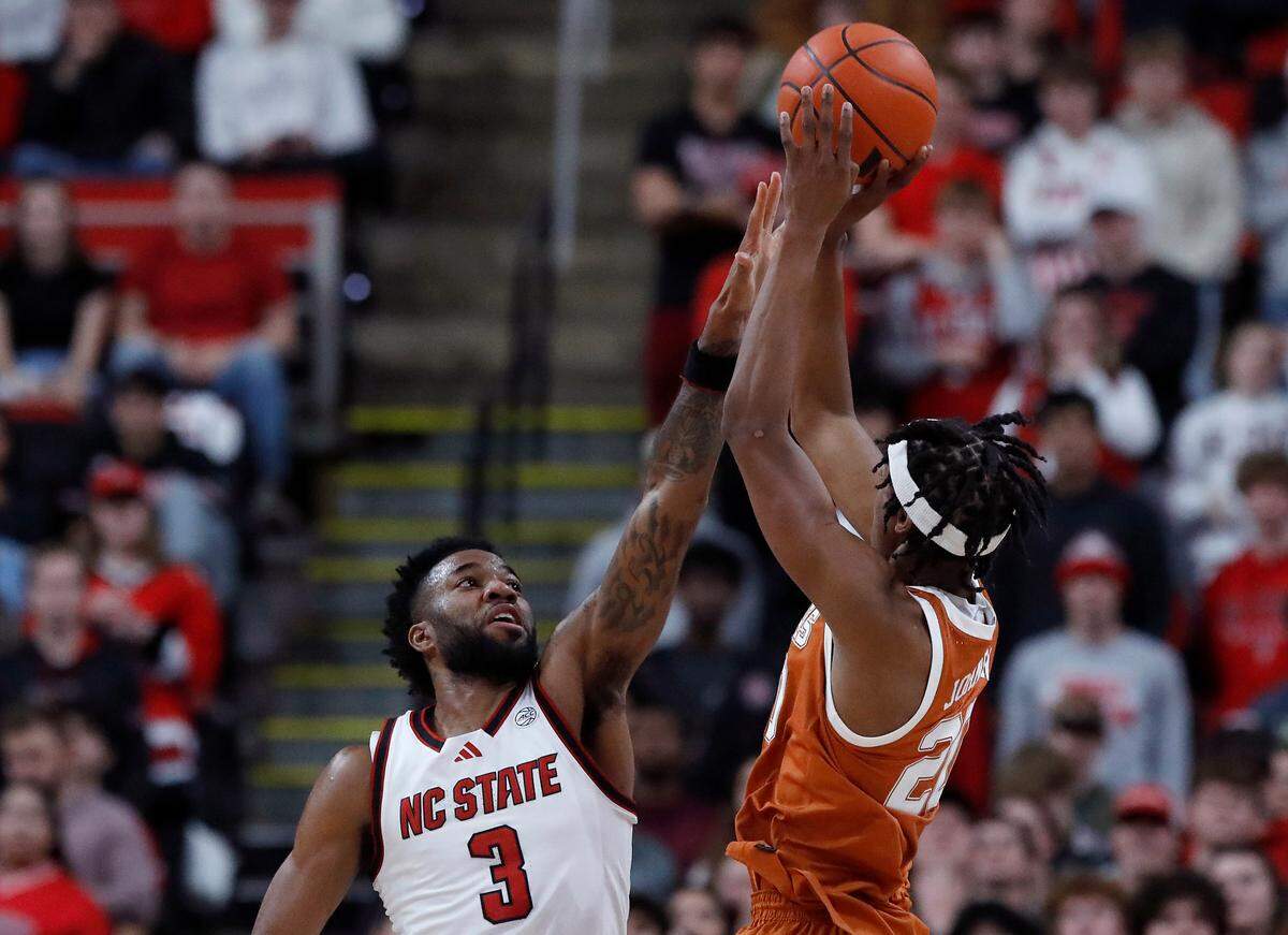 N.C. State’s Dontrez Styles pressures a shot by Texas’ Tre Johnson during the second half of the Wolfpack’s 63-59 loss on Wednesday, Dec. 4, 2024, at Lenovo Center in Raleigh, N.C.
