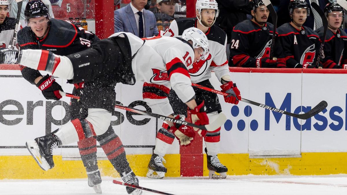 Carolina Hurricane right wing Andrei Svechnikov (37) checks New Jersey DevilsÕ Ondrej Palat (18) in the first period on Sunday, April 20, 2025 at Lenovo Center in Raleigh, N.C.