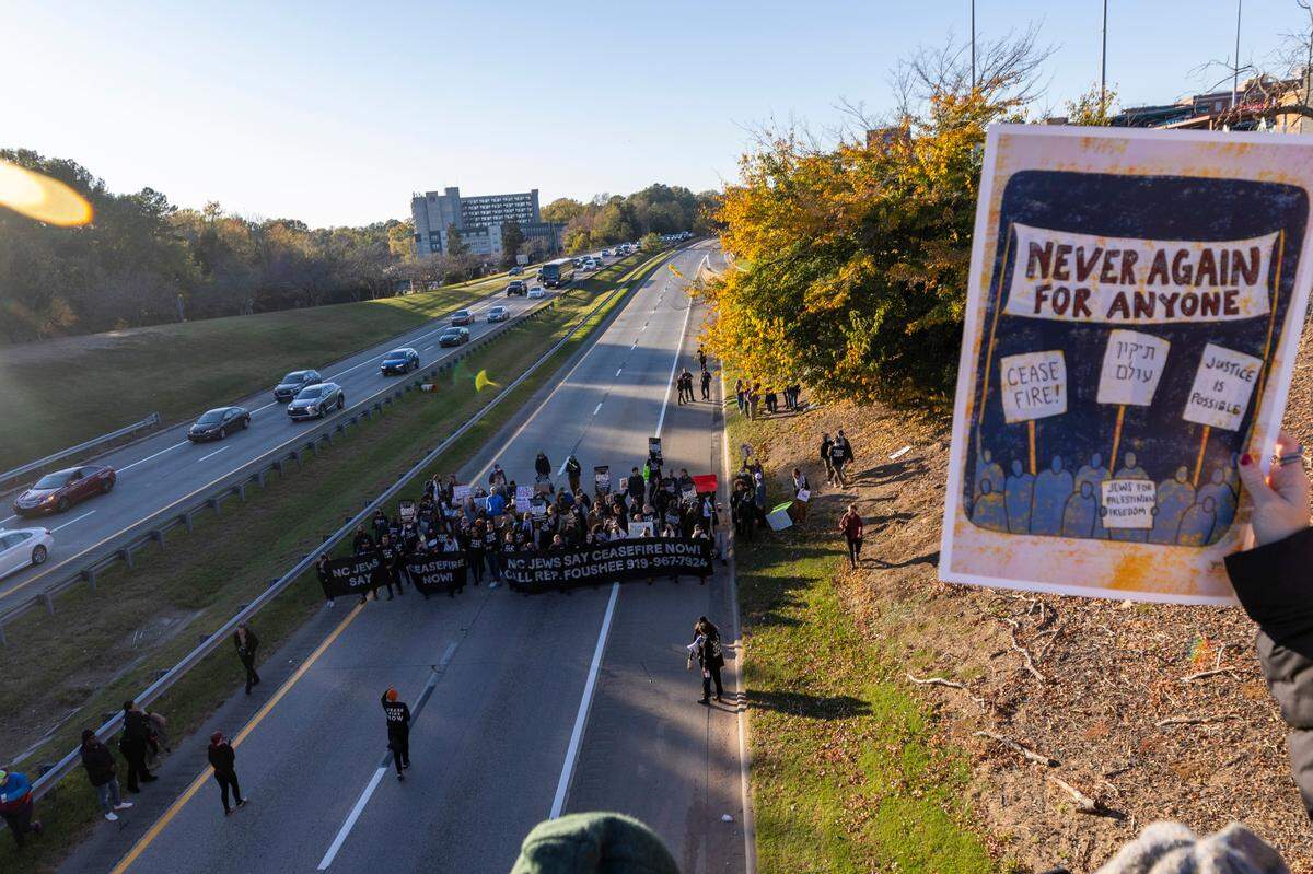 Protesters watch from the South Magnum Street bridge as some protesters block the northbound lanes of the Durham Freeway Thursday evening, Nov. 2, 2023. The demonstrators were demanding a ceasefire in the Israel-Gaza War.