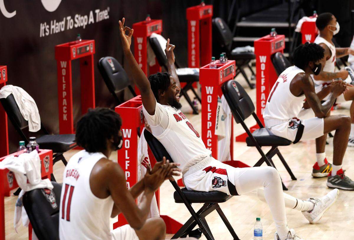 N.C. State’s D.J. Funderburk (0) celebrates after Thomas Allen made a three-pointer during the second half of N.C. State’s 86-51 victory over North Florida in the Mako Medical Wolfpack Invitational at Reynolds Coliseum in Raleigh, N.C., Friday, Nov. 27, 2020.