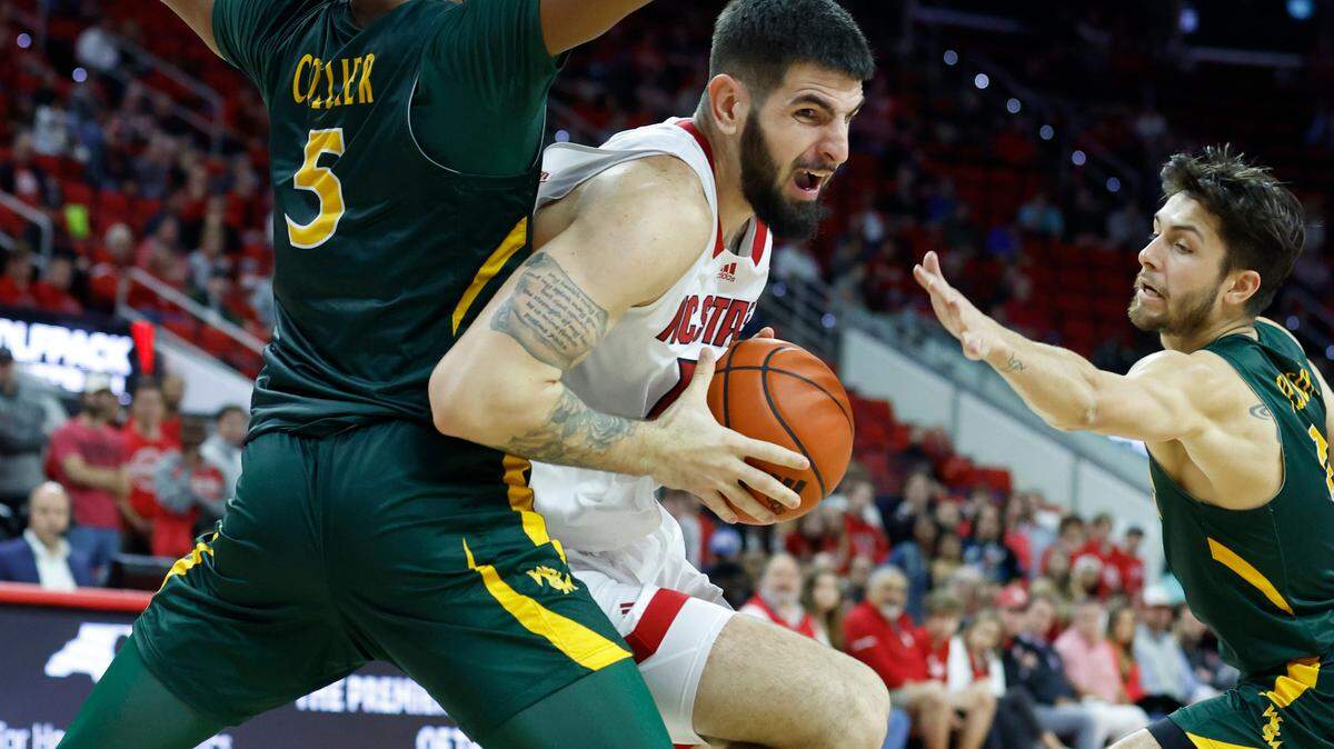 N.C. State’s Dusan Mahorcic (11) gets around William & Mary’s Noah Collier (5) during the second half of N.C. State’s 85-64 victory over William & Mary at PNC Arena in Raleigh, N.C., Tuesday, Nov. 29, 2022.