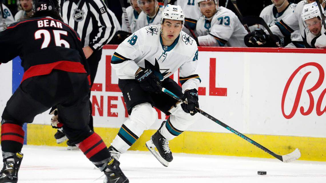 San Jose Sharks’ Timo Meier (28) moves the puck past Carolina Hurricanes’ Ethan Bear (25) during the third period of an NHL hockey game in Raleigh, N.C., Sunday, Jan. 30, 2022. (AP Photo/Karl B DeBlaker)