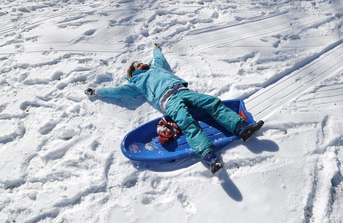 Paige Rowe takes a breather after sledding down one of the hills at Dix Park in Raleigh, N.C., Sunday, Feb. 1, 2026.