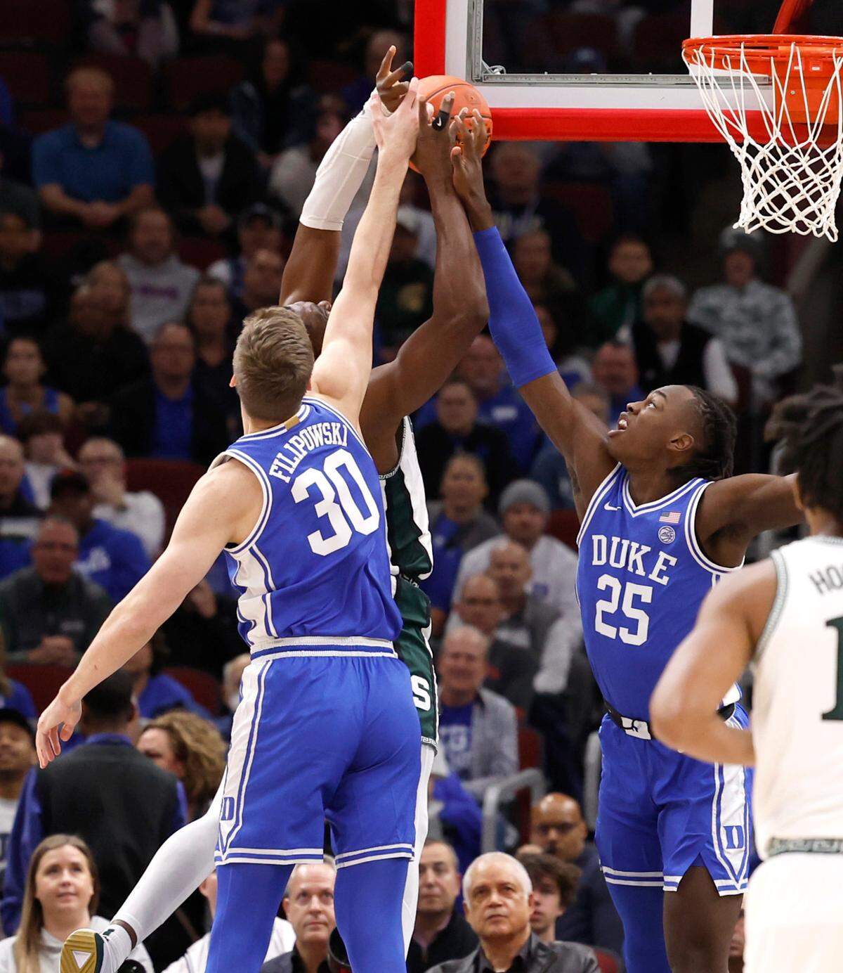 Duke’s Kyle Filipowski (30) and Mark Mitchell (25) block the shot by Michigan State’s Mady Sissoko (22) during the first half of Duke’s game against Michigan State in the Champions Classic at the United Center in Chicago, IL, Tuesday, Nov. 14, 2023.