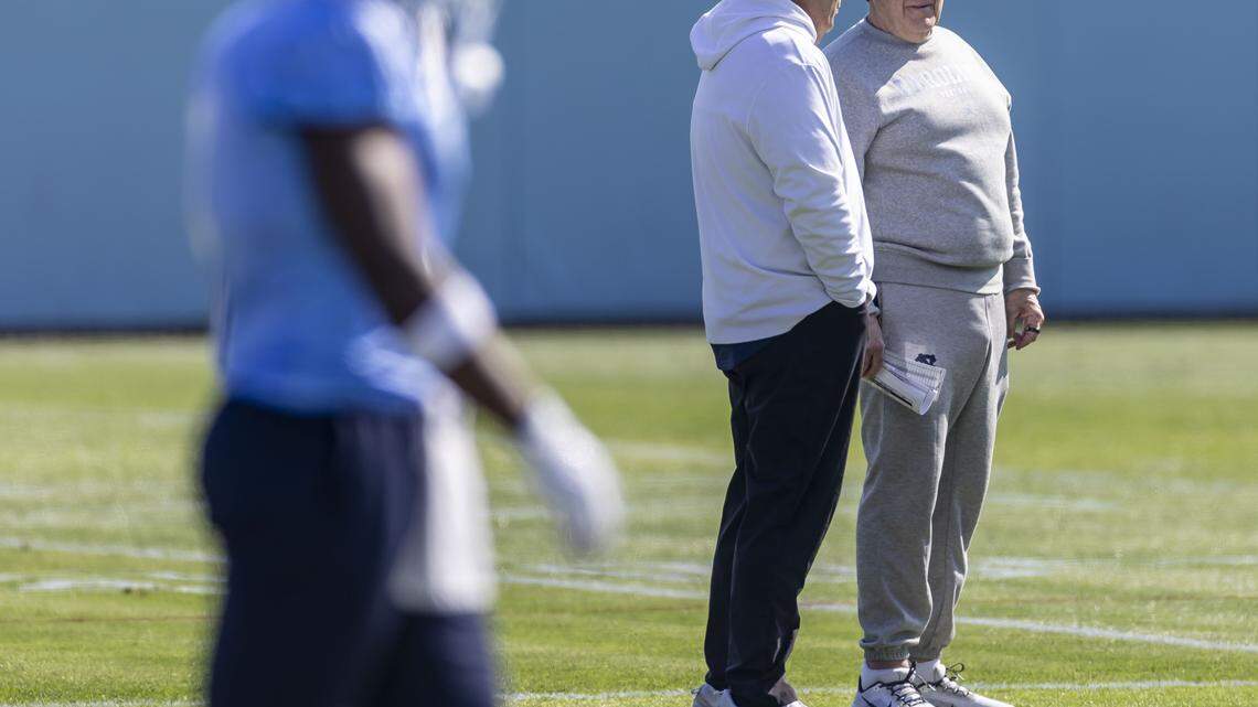 North Carolina coach Bill Belichick talks with general manager Michael Lombardi, during the Tar Heels’ spring practice, on Tuesday, March 24, 2026, at Kenan Stadium Chapel Hill, N.C.