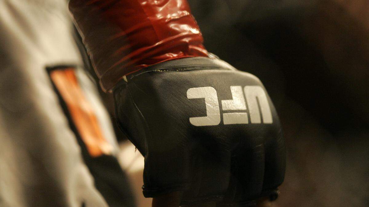 Closeup of a glove and the UFC logo at Ultimate Fighting Championship 73 on Saturday, July 7, 2007, in Sacramento, Calif. (AP Photo/Jeff Chiu)
