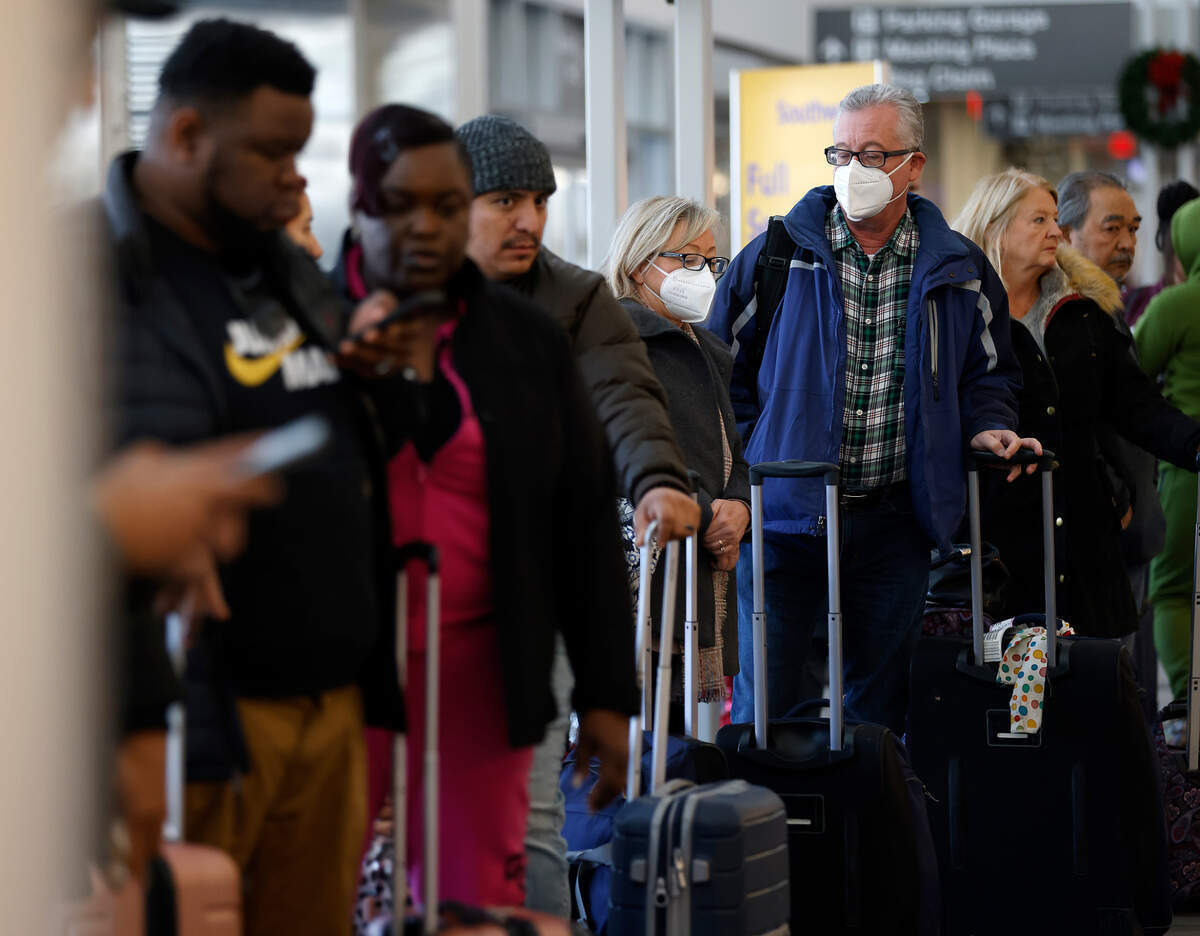 People wait in line at the Southwest ticketing counter on Tuesday, Dec. 27, 2022, at Raleigh-Durham International Airport.