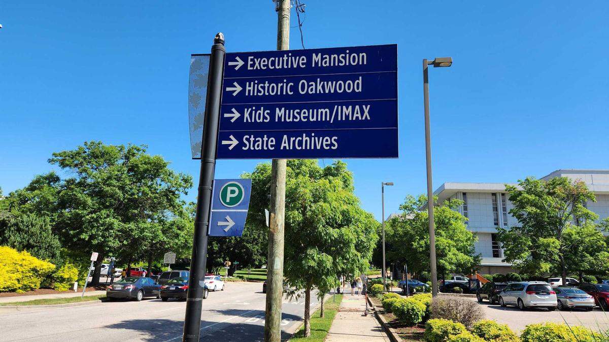 This directional sign shows visitors where key buildings are located. Visitors to downtown Raleigh in the state government area, which includes the Capitol, Legislative Building, Executive Mansion, museums and NC Freedom Park, now pay to park during weekdays in state-owned lots. Starting July 1, 2025, they will also be charged at night and on weekends.