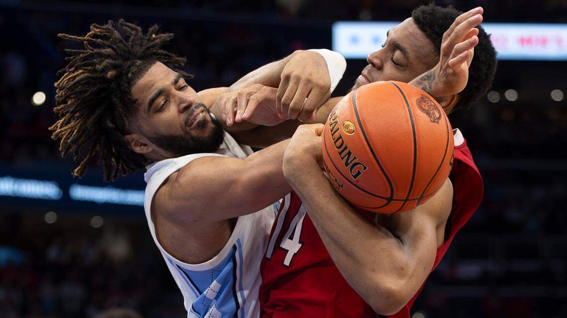 North Carolina’s R.J. Davis (4) tangles with Casey Morsell (14) for control of the ball in the second half during the ACC Men’s Basketball Tournament Championship at Capitol One Arena on Saturday, March 16, 2024 in Washington, D.C.