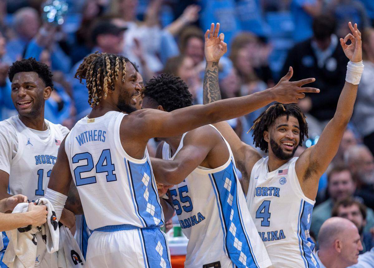North Carolina’s Jalen Washington (13), Jae’Lyn Withers (24), Harrison Ingram (55) and R.J. Davis (4) celebrate after a basket by reserve player Rob Landry (22) to give the Tar Heels a 90-65 lead in the final minute of play against Lehigh on Sunday, November 12, 2023 at the Smith Center in Chapel Hill, N.C.