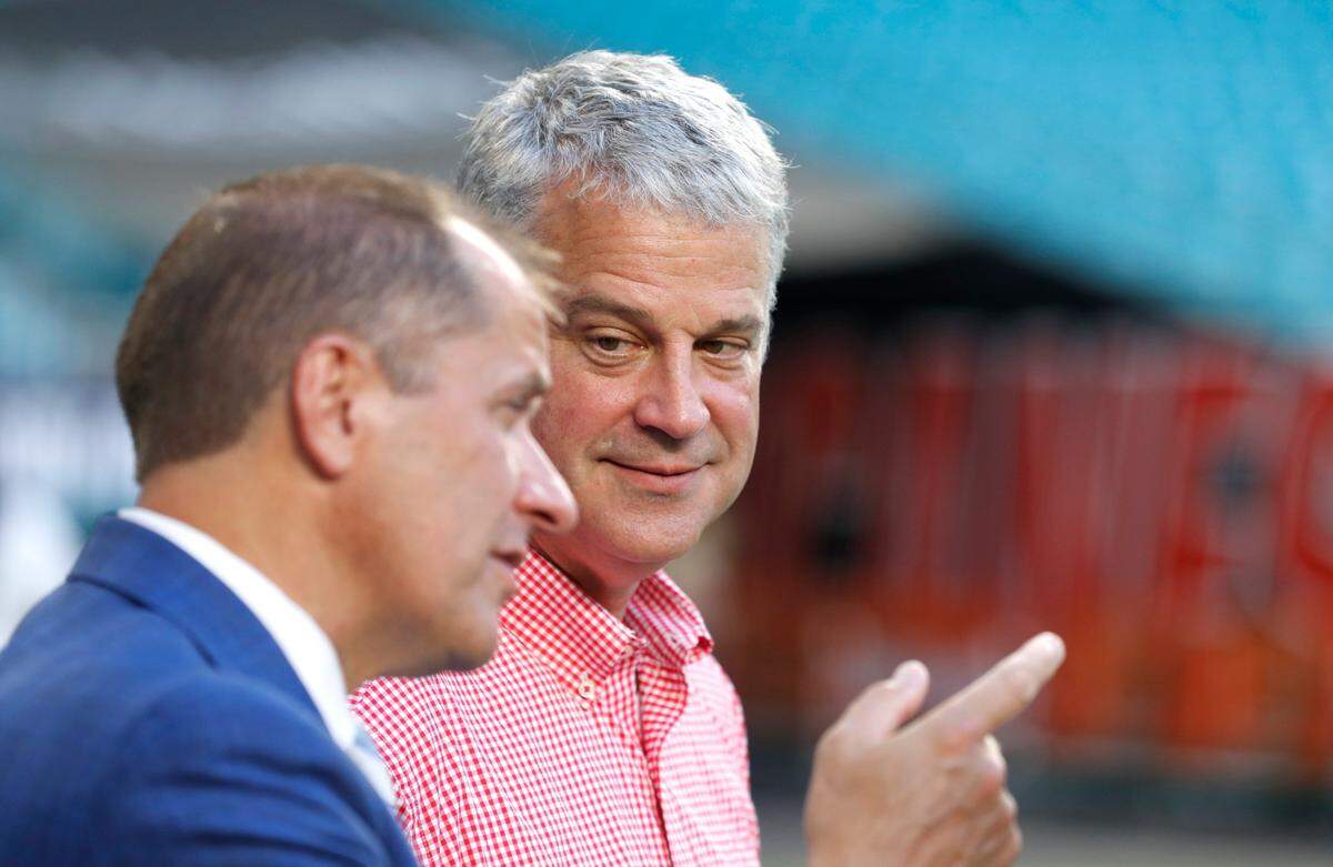 ACC commissioner Jim Phillips talks with N.C. State athletic director Boo Corrigan before the Wolfpacks game against Miami at Hard Rock Stadium in Miami Gardens, Fla. Saturday, Oct. 23, 2021.