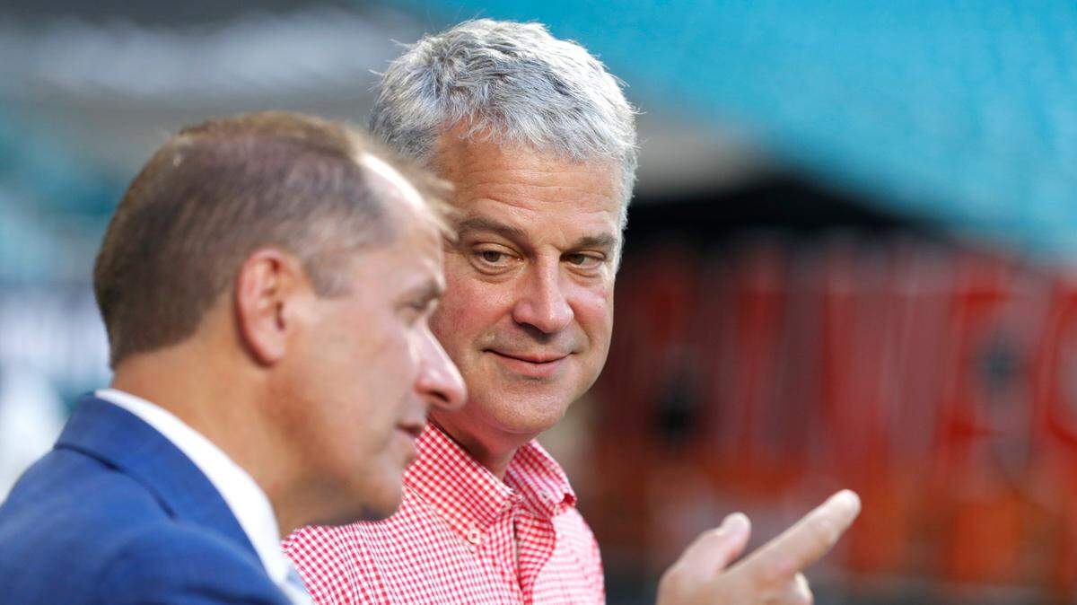 ACC commissioner Jim Phillips talks with N.C. State athletic director Boo Corrigan before the Wolfpacks game against Miami at Hard Rock Stadium in Miami Gardens, Fla. Saturday, Oct. 23, 2021.