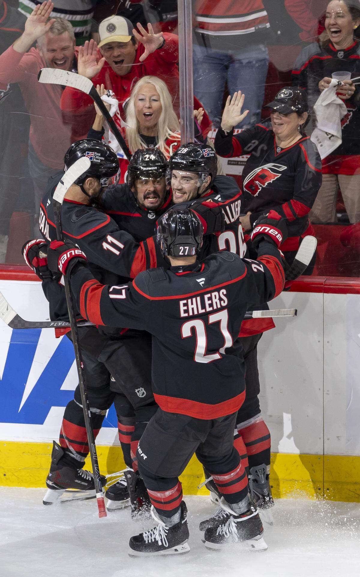 Carolina Hurricanes center Seth Jarvis (24) celebrates with Jordan Staal (11) Sean Walker (26), and Nikolaj Ehlers  (27) after scoring on Philadelphia goalie Dan Vladar (80) to tie the Flyers 2-2, in the third period on Monday, May 4, 2026, during the second round of the Stanley Cup Playoffs at Lenovo Center in Raleigh, N.C.
