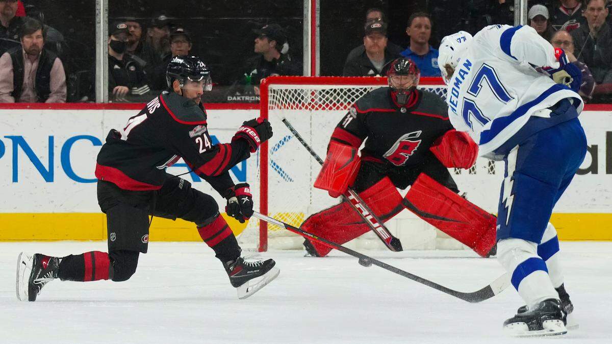 Mar 5, 2023; Raleigh, North Carolina, USA; Carolina Hurricanes center Seth Jarvis (24) goes out to block Tampa Bay Lightning defenseman Victor Hedman (77) shot during the first period at PNC Arena. Mandatory Credit: James Guillory-USA TODAY Sports