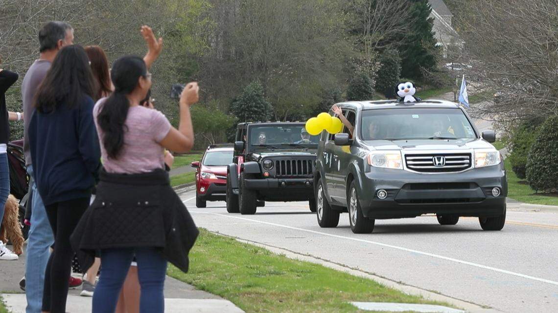 Teachers, staff and administrators from Laurel Park Elementary School in Apex parade up Westhigh Street in Cary, N.C., Friday, March 27, 2020. The teachers wanted to tell their students that they miss them and care about them.
