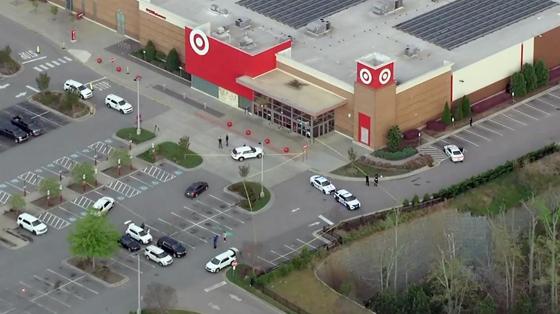 Holly Springs Police say officers shot a man who displayed a gun outside the Target store at 100 Grand Hill Place early Thursday morning.