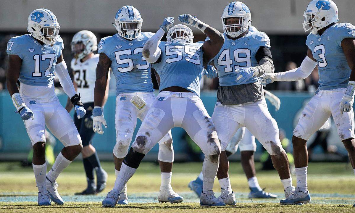 North Carolina’s Jason Strowbridge (55) celebrates with teammates after a defensive stop of Georgia Tech’s TaQuon Marshall (16) for a loss of three yards in the first quarter on Saturday, November 3, 2018 at Kenan Stadium in Chapel Hill, N.C.