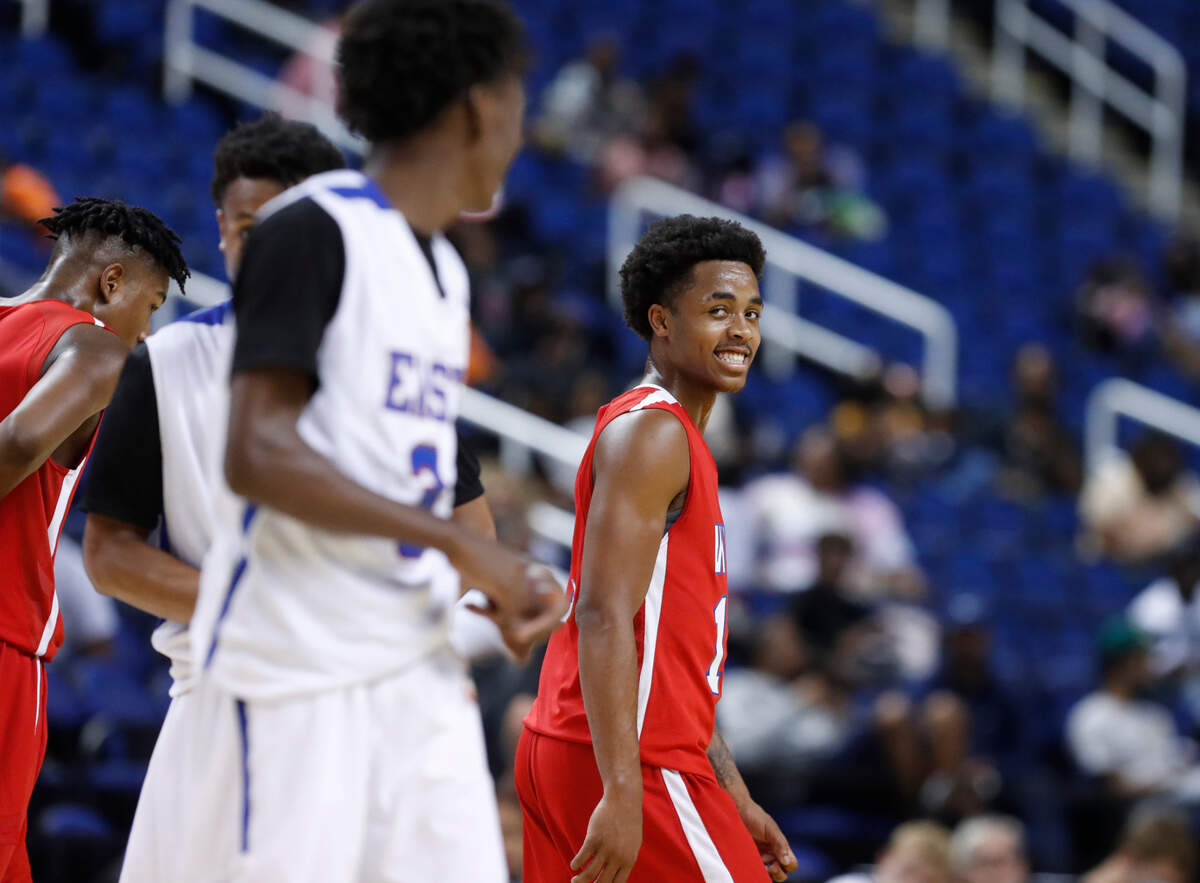 West’s Breon Pass (12), right, laughs with East’s Terquavion Smith (3) during the second half of the North Carolina High School Athletic Association men’s basketball All-Star game at Greensboro Coliseum in Greensboro, N.C., Monday, July 19, 2021.