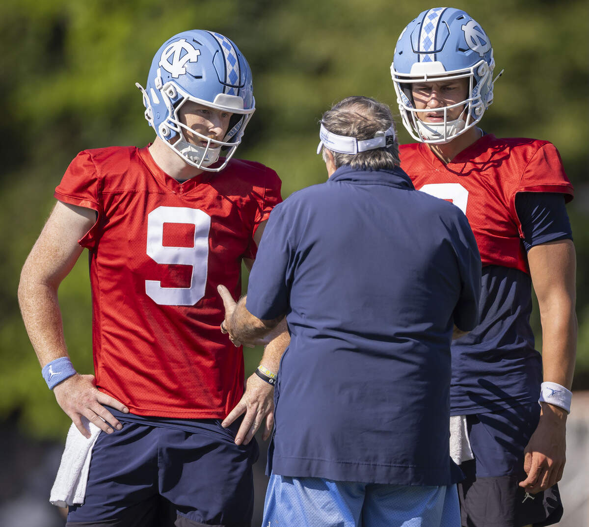 North Carolina coach Bill Belichick talks with quarterbacks Billy Edwards (8) and Miles O’Neil (8) during the Tar Heels’ practice on Thursday, July 30, 2026 in Chapel Hill, N.C.