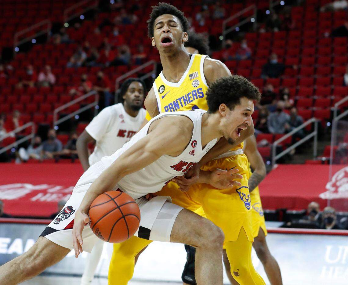 N.C. State’s Jericole Hellems (4) drives by Pittsburgh’s William Jeffress (24) during the second half of N.C. State’s 65-62 victory over Pittsburgh at PNC Arena in Raleigh, N.C., Sunday, February 28, 2021.