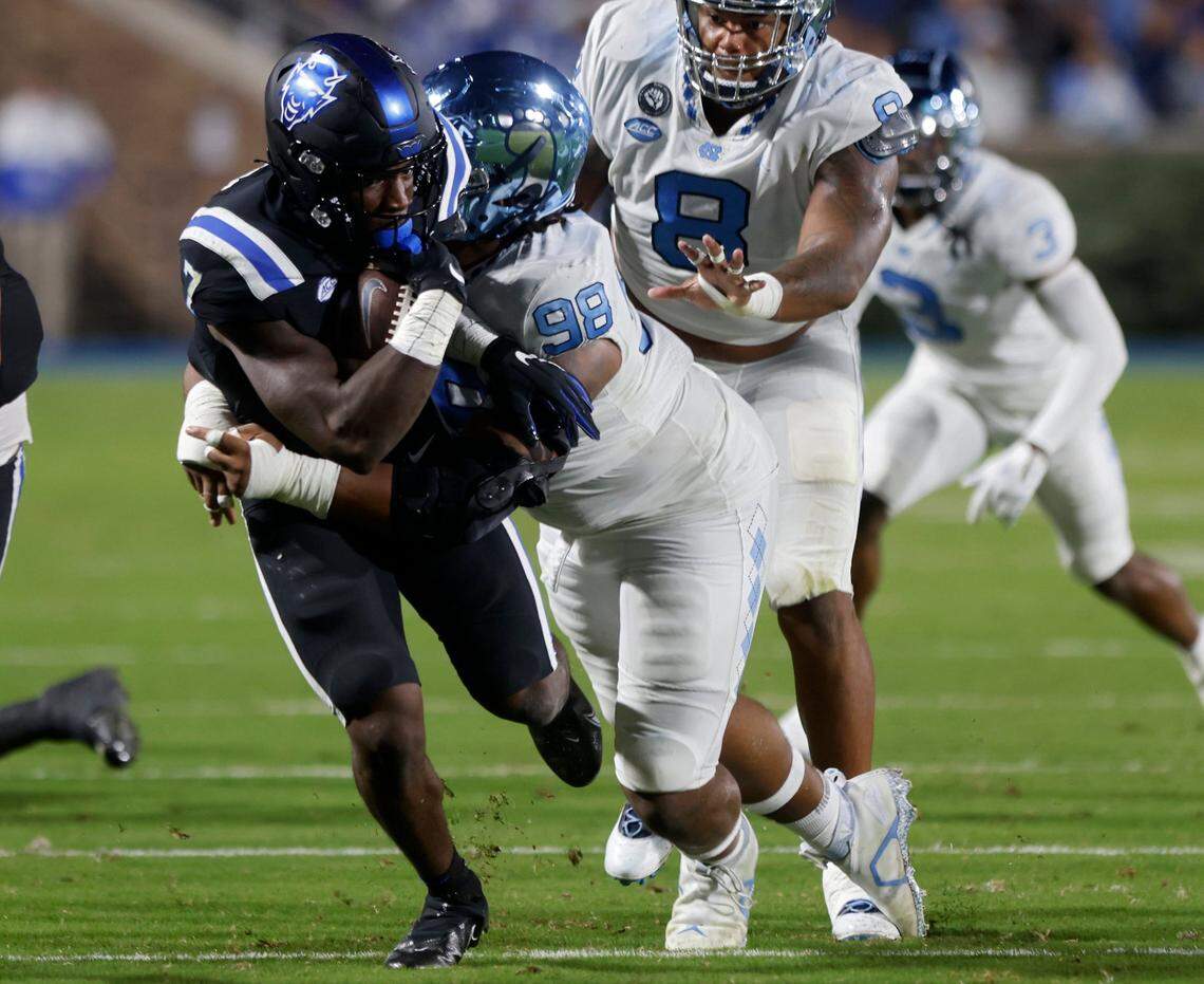 Duke Blue Devils running back Jordan Waters is brought down by North Carolina Tar Heels defensive lineman Kevin Hester Jr. on Saturday, Oct. 15, 2022, at Wallace Wade Stadium in Durham, N.X.