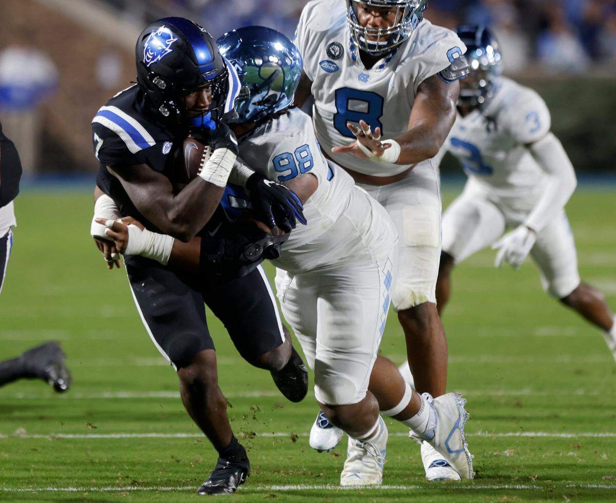 Duke Blue Devils running back Jordan Waters is brought down by North Carolina Tar Heels defensive lineman Kevin Hester Jr. on Saturday, Oct. 15, 2022, at Wallace Wade Stadium in Durham, N.X.